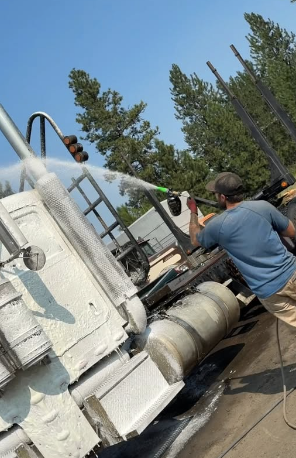 Gem State Pressure Washing technician cleaning a large industrial tanker truck