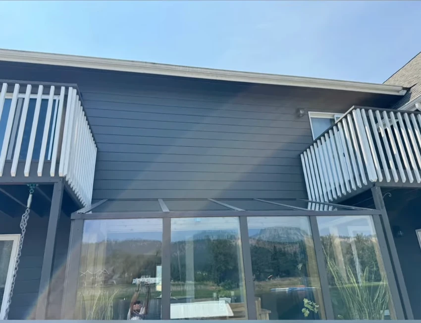 Clean lakeside siding and white balcony railings after a soft wash